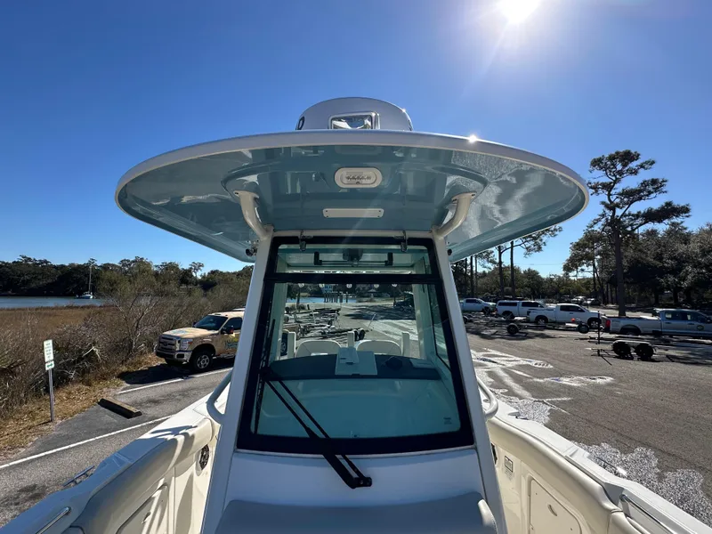 Slide: The Image of 2023 Boston Whaler 280 Outrage boat docked under clear blue sky. - 26