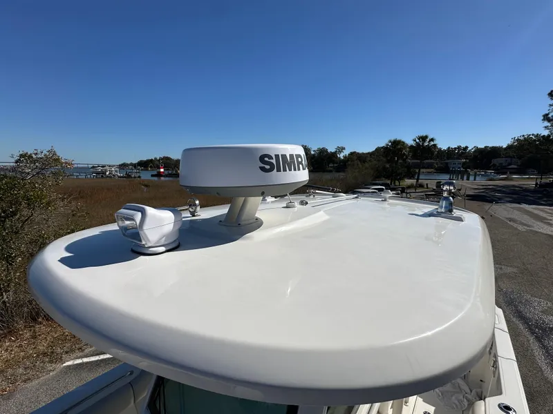 Slide: The Image of 2023 Boston Whaler 280 Outrage boat with Simrad radar on the roof, clear blue sky. - 27