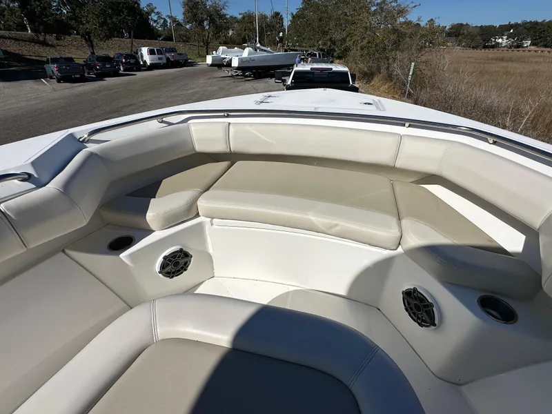 Slide: The Image of 2023 Boston Whaler 280 Outrage boat interior with cushioned seating and cup holders. - 28