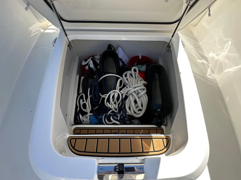 Slide: The Image of 2023 Boston Whaler 280 Outrage storage compartment with ropes and equipment. - 30