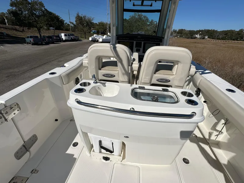 Slide: The Image of 2023 Boston Whaler 280 Outrage boat interior with seating and console. - 31