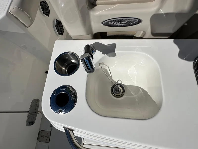 Slide: The Image of Boston Whaler 280 Outrage 2023 boat sink and cup holders detail. - 32