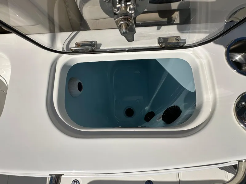 Slide: The Image of Livewell on 2023 Boston Whaler 280 Outrage boat, open lid, white and blue interior. - 33