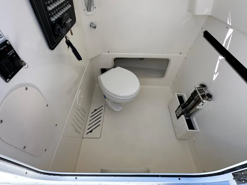 Slide: The Image of 2023 Boston Whaler 280 Outrage interior with marine toilet and storage compartments. - 36