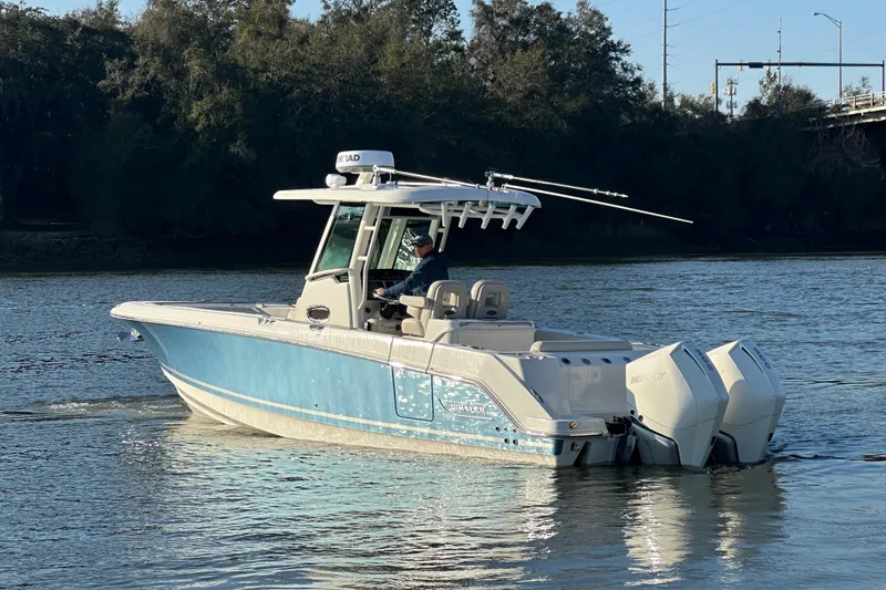 Slide: The Image of 2023 Boston Whaler 280 Outrage boat cruising on a calm river. - 4
