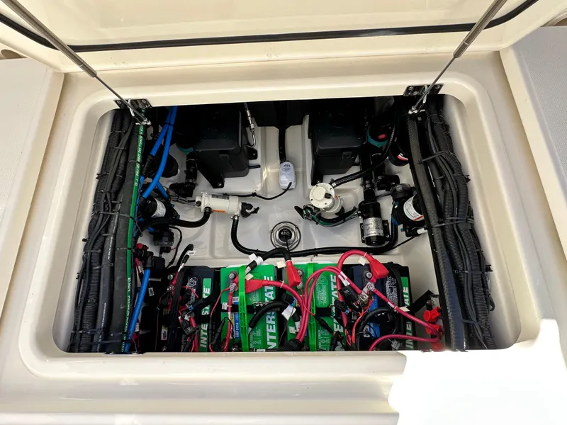 Slide: The Image of 2023 Boston Whaler 280 Outrage battery compartment with wiring and components. - 44