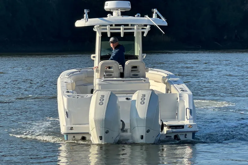 Slide: The Image of 2023 Boston Whaler 280 Outrage boat on water, rear view with dual engines. - 6