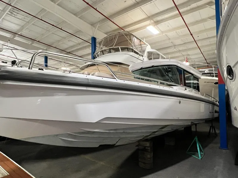 Slide: The Image of 2022 Axopar 28 CABIN boat in indoor storage facility. - 0