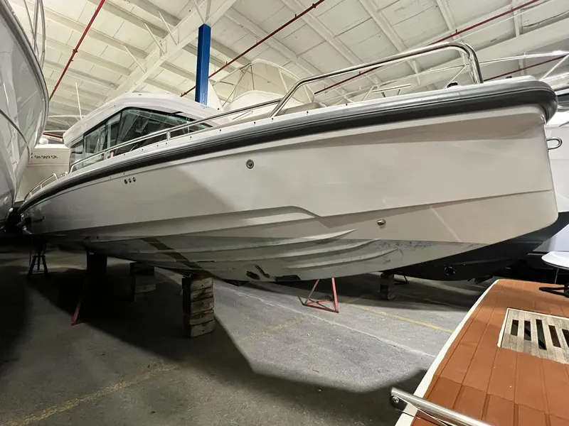 Slide: The Image of 2022 Axopar 28 CABIN boat in indoor storage facility. - 1