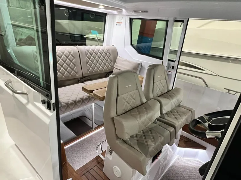 Slide: The Image of Interior of 2022 Axopar 28 CABIN boat with plush seating and modern design. - 11