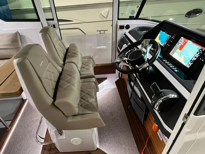 Slide: The Image of 2022 Axopar 28 CABIN interior with dual seats and modern navigation system. - 13