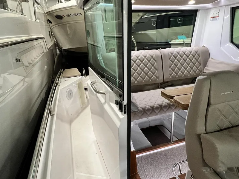 Slide: The Image of 2022 Axopar 28 CABIN interior with quilted seating and sleek design. - 14