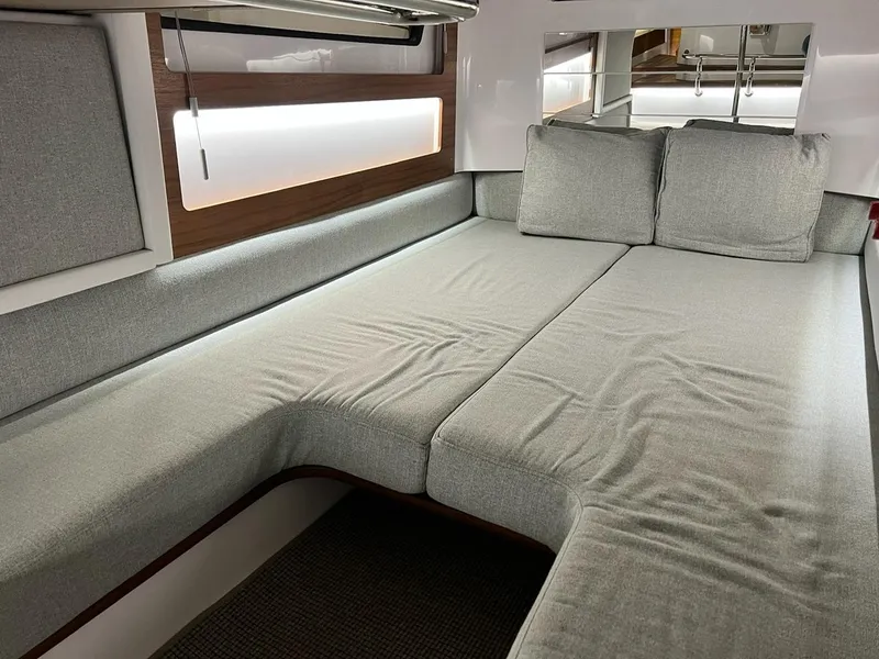 Slide: The Image of 2022 Axopar 28 CABIN interior with modern gray seating and ambient lighting. - 15