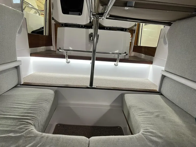 Slide: The Image of 2022 Axopar 28 CABIN interior with cushioned seating and modern design. - 16