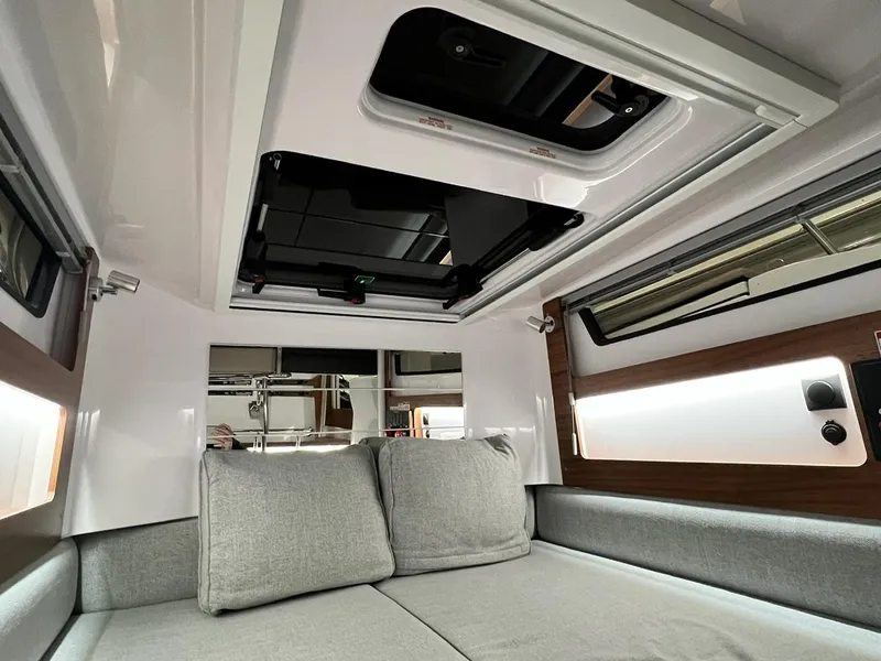 Slide: The Image of Interior of 2022 Axopar 28 CABIN, featuring modern design with gray cushions and sleek finishes. - 17