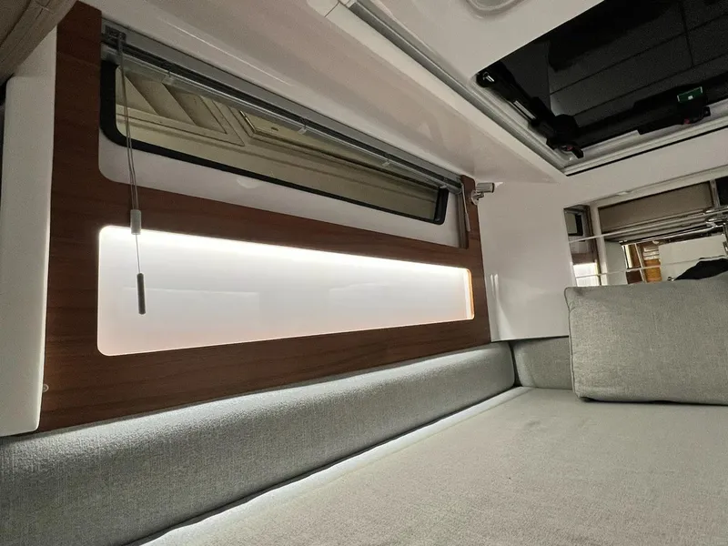 Slide: The Image of Interior of 2022 Axopar 28 CABIN with modern seating and ambient lighting. - 18