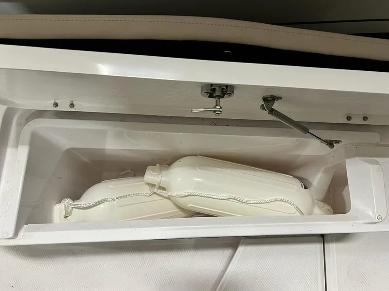 Slide: The Image of Storage compartment with fenders in 2022 Axopar 28 CABIN boat. - 25