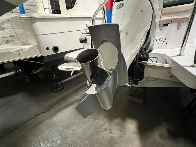 Slide: The Image of 2022 Axopar 28 CABIN boat propeller in a showroom setting. - 27