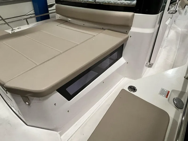 Slide: The Image of 2022 Axopar 28 CABIN interior seating area with beige cushions. - 4