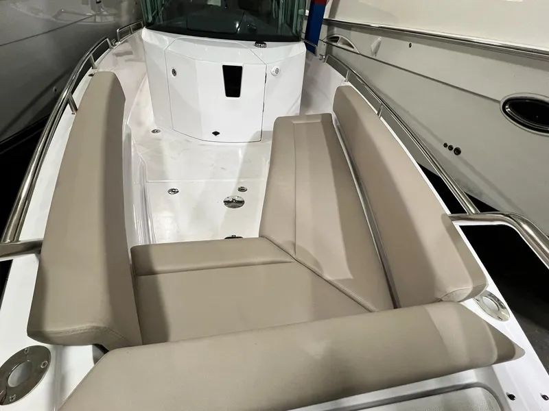 Slide: The Image of 2022 Axopar 28 CABIN boat interior with beige seating and sleek design. - 8