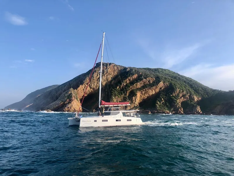 Slide: The Image of Sailboat Vision 444 cruising near rocky coastline, clear skies, 2026 model. - 8