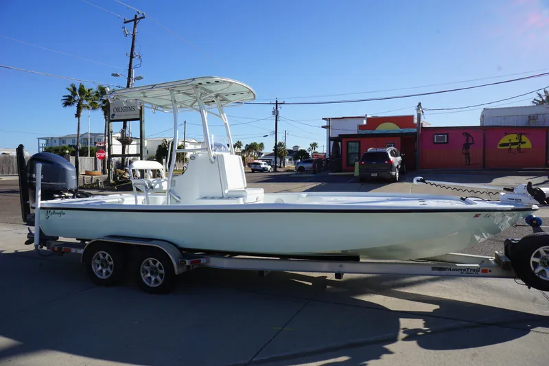 Slide: The Image of 2015 Yellowfin 24 Bay boat on trailer in urban setting, sunny day. - 1