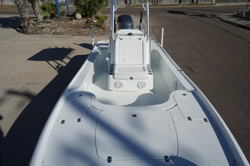 Slide: The Image of 2015 Yellowfin 24 Bay boat with spacious deck and center console, parked outdoors. - 13