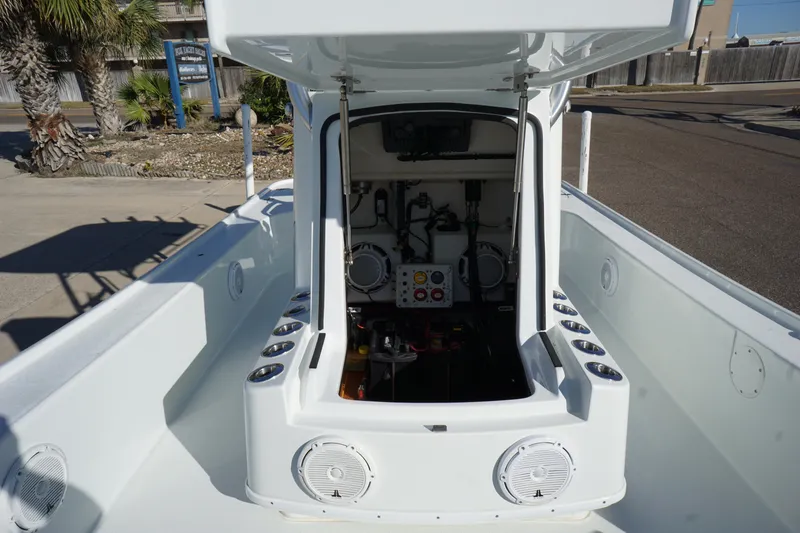 Slide: The Image of 2015 Yellowfin 24 Bay boat interior with open console, showcasing storage and equipment. - 14