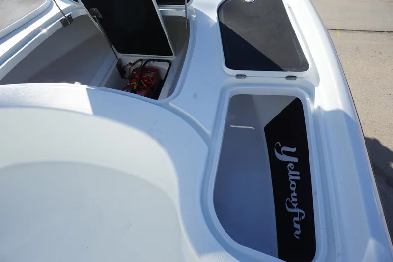 Slide: The Image of 2015 Yellowfin 24 Bay boat interior with open storage compartments. - 19