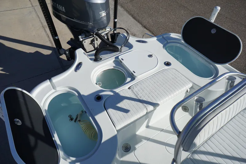 Slide: The Image of 2015 Yellowfin 24 Bay boat deck with seating and storage compartments. - 22