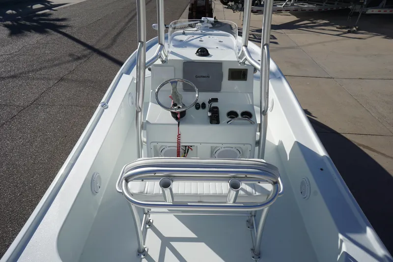 Slide: The Image of 2015 Yellowfin 24 Bay boat interior with steering console and seating. - 8