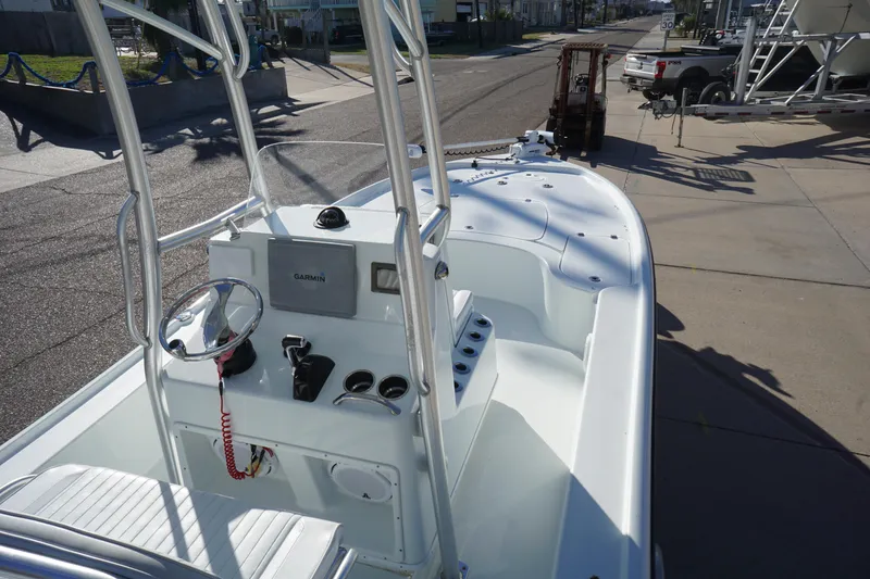 Slide: The Image of 2015 Yellowfin 24 Bay boat with center console and steering wheel, parked on a street. - 9