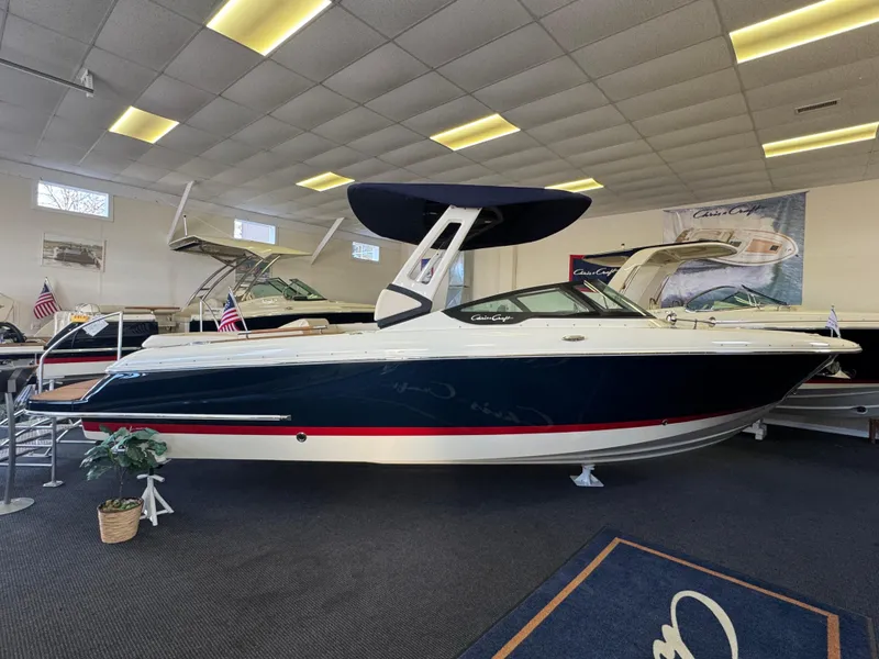 The Image of 2025 Chris-Craft Sportster 28 boat displayed in showroom with sleek design and modern features. - 0