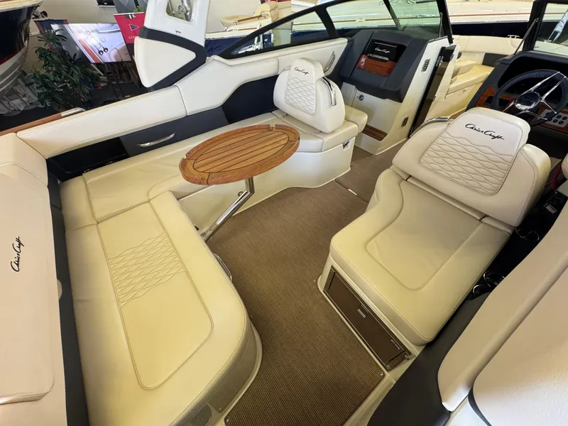 Slide: The Image of 2025 Chris-Craft Sportster 28 interior with luxurious seating and elegant wooden table. - 10