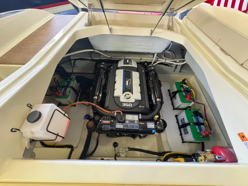 Slide: The Image of 2025 Chris-Craft Sportster 28 engine compartment with visible 350 horsepower engine and battery setup. - 11