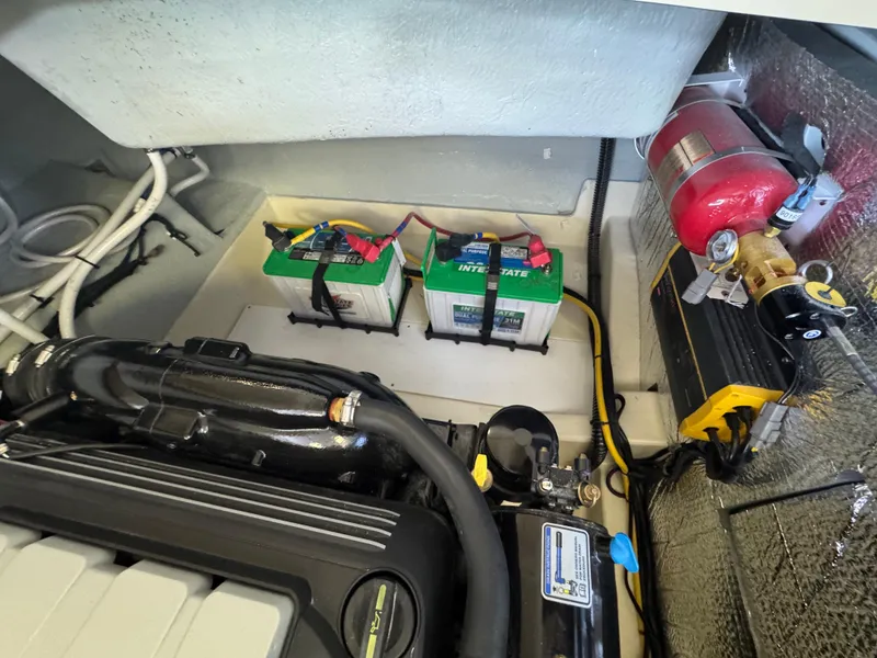 Slide: The Image of Engine compartment of 2025 Chris-Craft Sportster 28 with batteries and fire extinguisher. - 12
