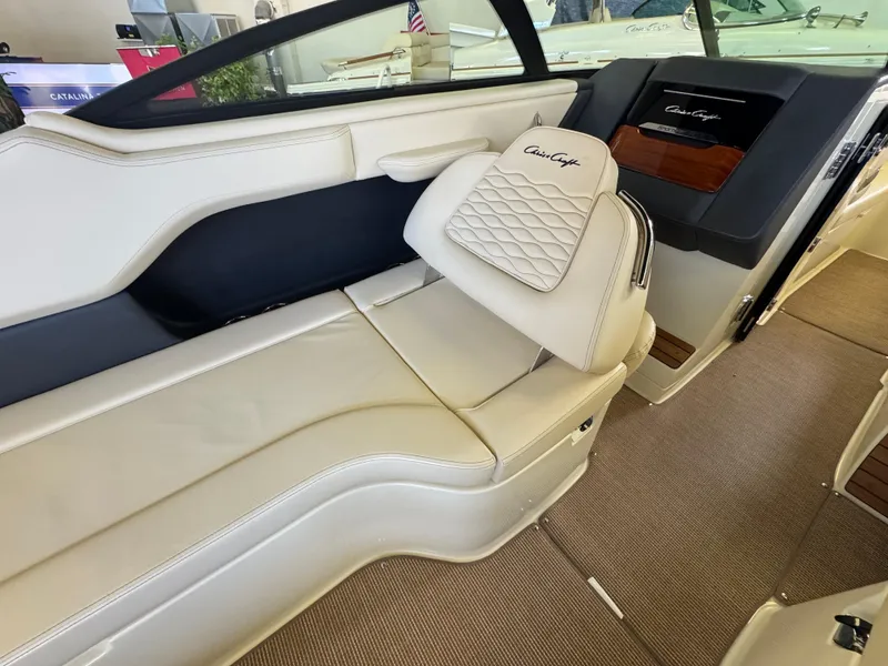 Slide: The Image of 2025 Chris-Craft Sportster 28 interior with luxurious white leather seating and elegant design. - 15
