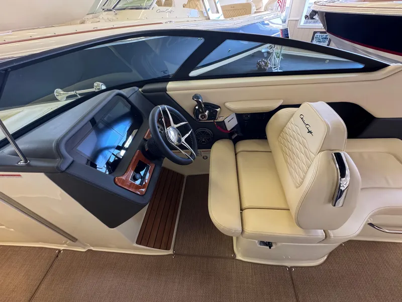 Slide: The Image of 2025 Chris-Craft Sportster 28 interior with beige seating and modern dashboard design. - 19