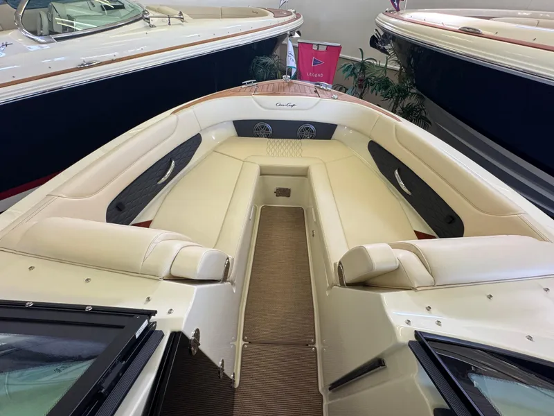 Slide: The Image of 2025 Chris-Craft Sportster 28 boat interior with beige seating and wood accents. - 23