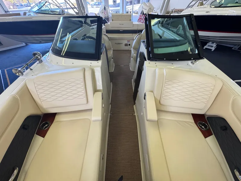 Slide: The Image of 2025 Chris-Craft Sportster 28 interior with luxurious white seating and modern design. - 24