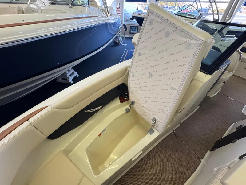 Slide: The Image of 2025 Chris-Craft Sportster 28 boat interior with open storage compartment. - 26
