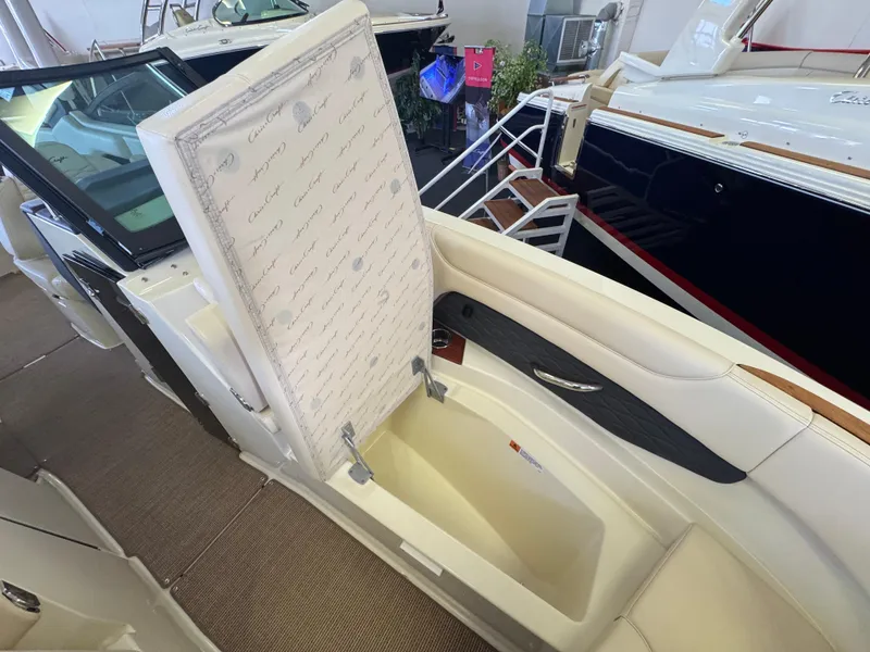Slide: The Image of 2025 Chris-Craft Sportster 28 boat interior with open storage compartment, showcasing luxury design. - 27