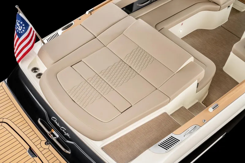 Slide: The Image of 2025 Chris-Craft Sportster 28 boat interior with beige seating and American flag. - 37