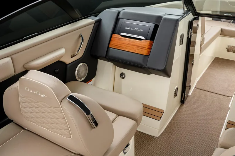 Slide: The Image of 2025 Chris-Craft Sportster 28 interior with beige leather seating and elegant dashboard design. - 44