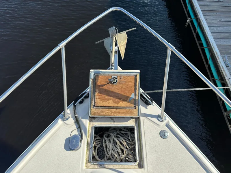 Slide: The Image of 1987 Sea Ray 300 Sedan Bridge bow with anchor and rope storage. - 12