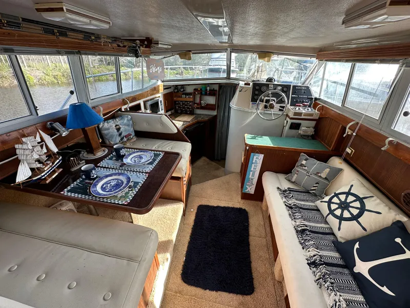 Slide: The Image of 1987 Sea Ray 300 Sedan Bridge interior with nautical decor and helm station. - 13