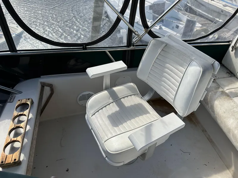 Slide: The Image of Captain's chair on 1987 Sea Ray 300 Sedan Bridge boat, overlooking marina. - 24