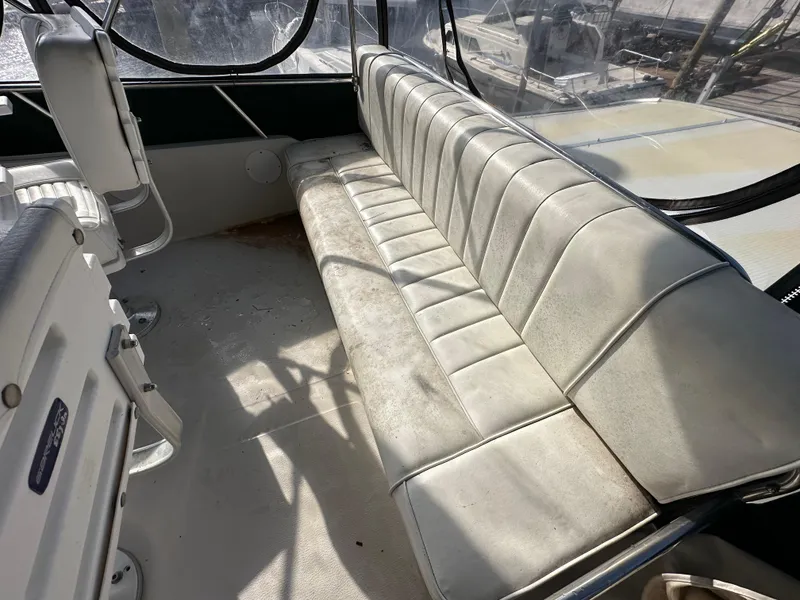 Slide: The Image of 1987 Sea Ray 300 Sedan Bridge interior with white leather seating and panoramic windows. - 25