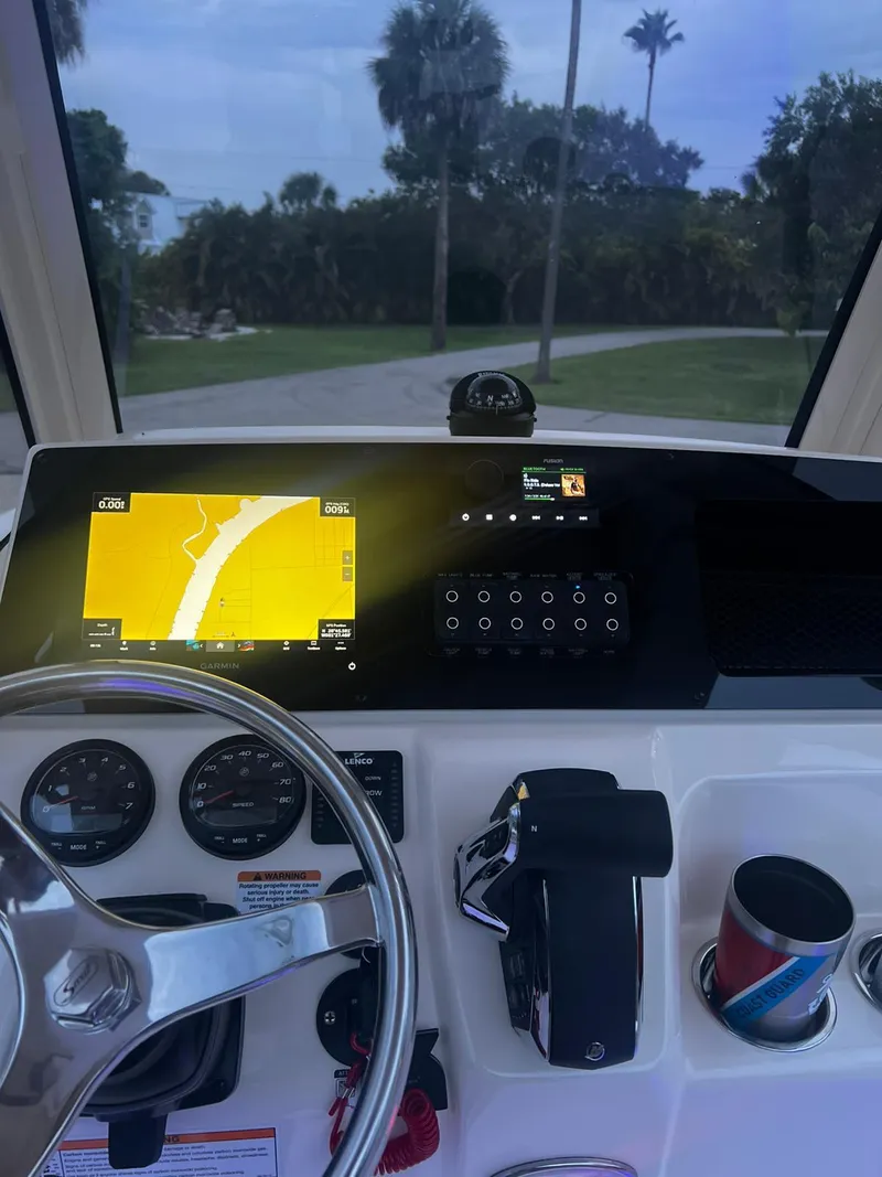 Slide: The Image of 2024 Scout 215 XSF boat dashboard with navigation display and controls. - 6