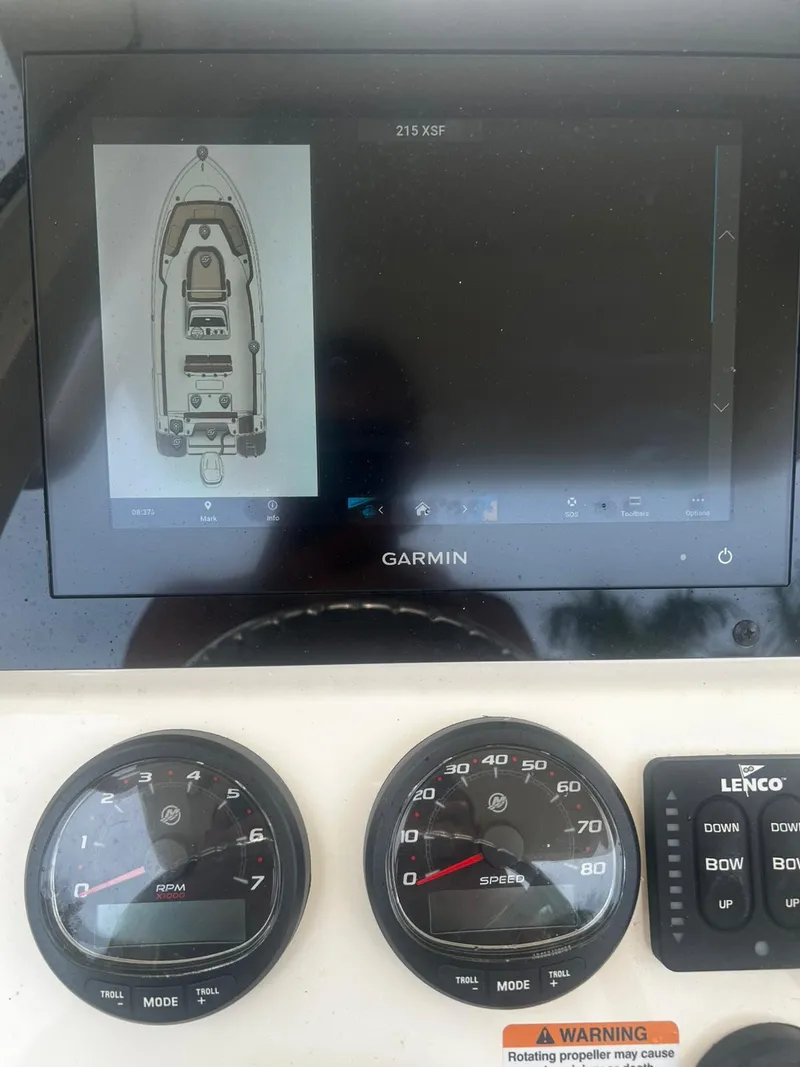 Slide: The Image of 2024 Scout 215 XSF boat dashboard with Garmin display and gauges. - 7